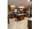 Eat-in kitchen with island, wood cabinetry, and tile flooring at 466 Sycamore Ridge Ct, Avon, IN 46123