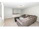 Cozy basement featuring carpet, a comfortable sofa, and natural light from the overhead light fixture at 5826 Winding Way Ln, Indianapolis, IN 46220