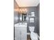 Charming powder room with a vanity, gray walls, and stylish light fixture at 5826 Winding Way Ln, Indianapolis, IN 46220