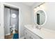 Well-lit bathroom with a single vanity and tile flooring. The shower is accessible through a doorway at 5826 Winding Way Ln, Indianapolis, IN 46220