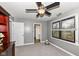 Neutral-toned bedroom with ceiling fan, double window view, and closet space with room for storage at 5826 Winding Way Ln, Indianapolis, IN 46220
