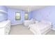 Bright bedroom featuring two twin beds, chandelier lighting, and a double window view for ample natural light at 5826 Winding Way Ln, Indianapolis, IN 46220