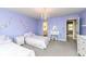 Charming bedroom with two twin beds, chandelier lighting, and a vanity, creating a cozy and inviting space at 5826 Winding Way Ln, Indianapolis, IN 46220
