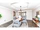 Stylish dining room features a tray ceiling, chandelier, and a view into the living room at 5826 Winding Way Ln, Indianapolis, IN 46220
