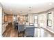 Spacious kitchen featuring a large island with seating, modern lighting, and access to the deck at 5826 Winding Way Ln, Indianapolis, IN 46220