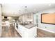 Open-concept kitchen with a large island, modern light fixtures, and sleek appliances at 5826 Winding Way Ln, Indianapolis, IN 46220