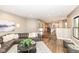 Spacious living room with open floor plan to kitchen, a fireplace, and a leather sectional at 5826 Winding Way Ln, Indianapolis, IN 46220