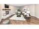 Cozy living room features a brick fireplace, dark brown leather sectional, and stylish decor at 5826 Winding Way Ln, Indianapolis, IN 46220