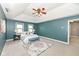 Bright main bedroom featuring a vaulted ceiling, stylish fan, and a patterned area rug at 5826 Winding Way Ln, Indianapolis, IN 46220