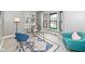 Bright office space with a glass desk, stylish blue chairs, and a bay window for natural light at 5826 Winding Way Ln, Indianapolis, IN 46220