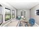 Well-lit office featuring large windows, comfortable seating, and a glass desk at 5826 Winding Way Ln, Indianapolis, IN 46220