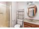 Bathroom featuring a shower, vanity, modern toilet, and a round mirror at 7655 Westerville Dr, Clayton, IN 46118