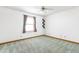 Bright bedroom with a large window, modern gray carpet, and a ceiling fan at 7655 Westerville Dr, Clayton, IN 46118