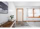 Inviting entryway featuring a charming front door, stylish console table, and ample natural light through the windows at 7655 Westerville Dr, Clayton, IN 46118