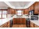 Well-equipped kitchen featuring wooden cabinets, modern appliances, and ample counter space at 7655 Westerville Dr, Clayton, IN 46118