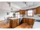 Charming kitchen with wood cabinets, stainless steel appliances, and adjacent dining area at 7655 Westerville Dr, Clayton, IN 46118
