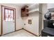 Functional laundry room with storage shelves, water system, and access to the outdoors at 7655 Westerville Dr, Clayton, IN 46118