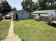 Well-maintained backyard with detached garages and parking for vehicles at 2811 Fenwood Ave, Terre Haute, IN 47803
