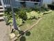 Close up view of the front yard with manicured landscaping and a street lamp at 2811 Fenwood Ave, Terre Haute, IN 47803