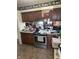 Kitchen featuring wood cabinetry, countertops, stainless steel oven, and tile flooring at 2811 Fenwood Ave, Terre Haute, IN 47803