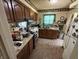 Functional kitchen featuring wood cabinetry, tile flooring, and stainless steel oven at 2811 Fenwood Ave, Terre Haute, IN 47803