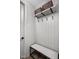 Entryway with gray paneled wall, bench, hooks, and shelf with baskets for stylish organization at 1676 Solebar Way, Westfield, IN 46074
