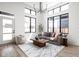 Bright living room with soaring windows, a modern chandelier, and comfortable furnishings at 1676 Solebar Way, Westfield, IN 46074