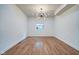Spacious dining room with wood floors, modern chandelier, natural light, and neutral paint at 1229 N Keystone Ave, Indianapolis, IN 46201