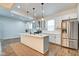 Modern kitchen with white cabinets, stainless steel appliances, and center island at 1229 N Keystone Ave, Indianapolis, IN 46201