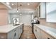 Bright kitchen with white cabinets, quartz counters, stainless appliances, hardwood floor and pendant lights at 1229 N Keystone Ave, Indianapolis, IN 46201