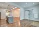Open kitchen boasts stainless appliances, kitchen island with seating, and a modern sliding barn door at 1229 N Keystone Ave, Indianapolis, IN 46201