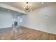 Bright living room with hardwood floors and modern light fixture at 1229 N Keystone Ave, Indianapolis, IN 46201