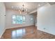 Living room showing hardwood floors, recessed lighting, and large window to backyard at 1229 N Keystone Ave, Indianapolis, IN 46201