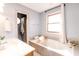 Relaxing bathroom with a soaking tub, vanity, and bright natural light at 10909 Wonderland Dr, Indianapolis, IN 46239