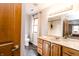 Bathroom featuring a double vanity with marble countertop and wooden cabinets at 10909 Wonderland Dr, Indianapolis, IN 46239