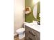 Stylish half bath with geometric wallpaper, round mirror and modern vanity at 10909 Wonderland Dr, Indianapolis, IN 46239