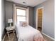 Cozy bedroom featuring a twin bed next to a sunlit window and closet at 10909 Wonderland Dr, Indianapolis, IN 46239