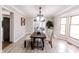 Well-lit dining room with a wooden table, upholstered chairs, and large windows at 10909 Wonderland Dr, Indianapolis, IN 46239