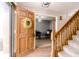 Bright entryway with a wooden front door, staircase, and an open view to a study at 10909 Wonderland Dr, Indianapolis, IN 46239