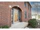 Charming brick home featuring an arched entryway and a well-maintained lawn at 10909 Wonderland Dr, Indianapolis, IN 46239