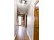 Inviting hallway with hardwood floors leading to a bright, open doorway at 10909 Wonderland Dr, Indianapolis, IN 46239