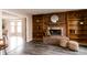 Inviting living room with a brick fireplace, built-in bookshelves, and hardwood flooring at 10909 Wonderland Dr, Indianapolis, IN 46239
