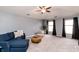 Bright living room with a comfortable blue sofa, stylish decor, and ample natural light at 10909 Wonderland Dr, Indianapolis, IN 46239