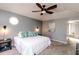 Serene main bedroom with a ceiling fan and an adjacent bathroom at 10909 Wonderland Dr, Indianapolis, IN 46239