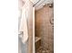Modern tiled shower with built-in seat, handheld shower, and neutral colors at 10909 Wonderland Dr, Indianapolis, IN 46239