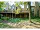 Multi-level deck on a home with stone chimneys and mature trees, creating a relaxing outdoor space at 4695 Shireton Ct, Indianapolis, IN 46254