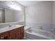Bathroom with tub, vanity, and large mirror at 4695 Shireton Ct, Indianapolis, IN 46254