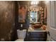 Stylish powder room featuring a decorative sink, elegant mirror, and sophisticated decor at 4695 Shireton Ct, Indianapolis, IN 46254
