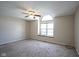 Bright bedroom featuring a large arched window and ceiling fan at 4695 Shireton Ct, Indianapolis, IN 46254