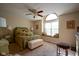 Sunlit bedroom features a ceiling fan and a charming window seat, providing a cozy space for reading or relaxing at 4695 Shireton Ct, Indianapolis, IN 46254